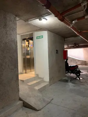 a parking garage with a scooter parked in front of an elevator at Apartamento 5 Carcano in Villa Carlos Paz