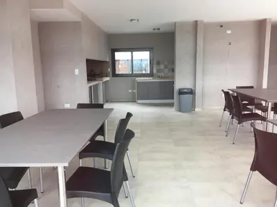 an empty dining room with tables and chairs at Apartamento 5 Carcano in Villa Carlos Paz