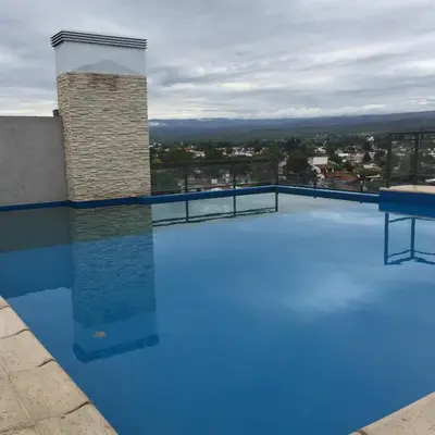 a large swimming pool on the roof of a building at Apartamento 5 Carcano in Villa Carlos Paz