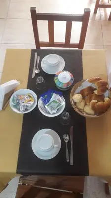 a table with plates of food on top of it at Hostería Tejas Negras in Mina Clavero