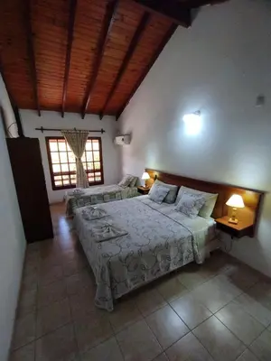 a bedroom with two beds and two lamps in it at Hostería Tejas Negras in Mina Clavero