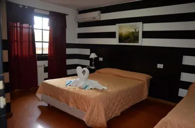 a bedroom with a bed with a bunny on it at Hotel Valle Del Sol in Merlo