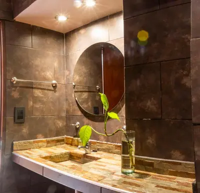 a bathroom with a sink and a mirror at Hotel Valle Del Sol in Merlo