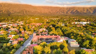 an aerial view of a city with mountains in the background at Hotel Valle Del Sol in Merlo