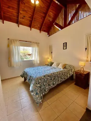 a bedroom with a bed in a room with a window at Sonnen Haus in Villa General Belgrano