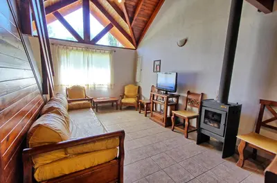 a living room with a couch and a wood stove at Sonnen Haus in Villa General Belgrano
