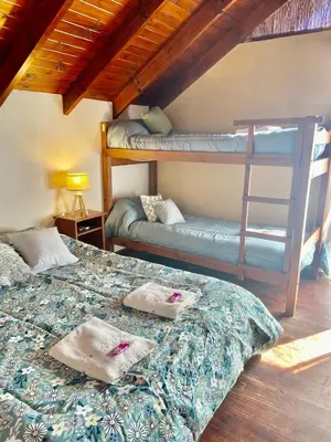 a bedroom with two bunk beds and a ladder at Sonnen Haus in Villa General Belgrano