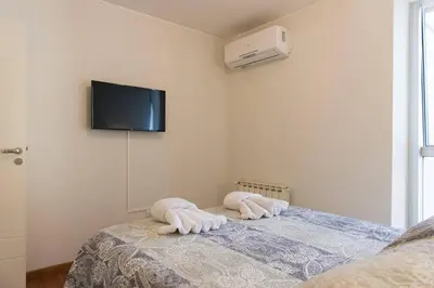 a bedroom with a bed with a tv on the wall at Nueva Córdoba Duomo in Cordoba