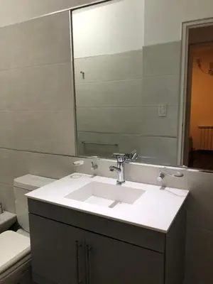 a bathroom with a sink and a mirror and a toilet at Nueva Córdoba Duomo in Cordoba