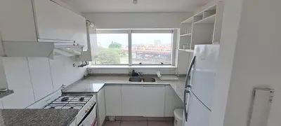 a kitchen with a white refrigerator and a window at Nueva Córdoba Duomo in Cordoba