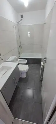a bathroom with two toilets and a sink and a tub at Nueva Córdoba Duomo in Cordoba