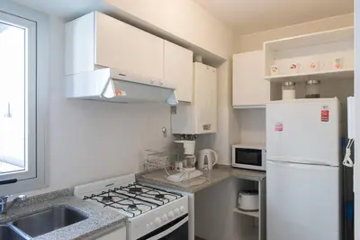 a kitchen with white appliances and a white refrigerator at Nueva Córdoba Duomo in Cordoba