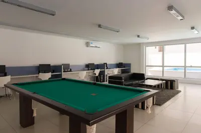 a billiard room with a pool table and chairs at Nueva Córdoba Duomo in Cordoba
