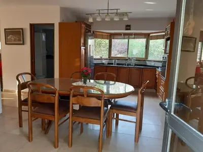 a kitchen with a dining room table and chairs at Descanso las Tres Marias Apart Hotel in Villa Carlos Paz