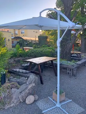 a picnic table with an umbrella in a park at Descanso las Tres Marias Apart Hotel in Villa Carlos Paz