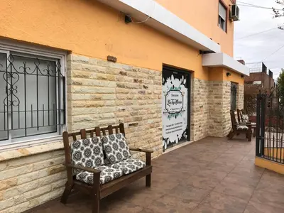 a bench sitting on a patio in front of a building at Descanso las Tres Marias Apart Hotel in Villa Carlos Paz