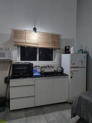 a kitchen with a stove and a refrigerator at Aires de Ambar in Merlo