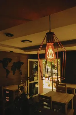 a chandelier in a dining room with a table and a dining room at Hostel Avetaia in Santa Rosa de Calamuchita