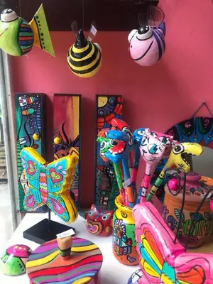 a group of colorful vases sitting on a table at Hostel Avetaia in Santa Rosa de Calamuchita