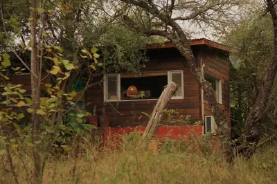 a small house with a pumpkin in a window at Samsara Traslasierra in Los Hornillos