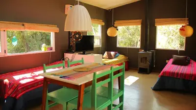 a room with a table and a bed at Samsara Traslasierra in Los Hornillos