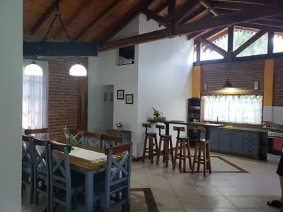 a kitchen with a table and chairs in a room at Complejo Tierra Mia in Panaholma