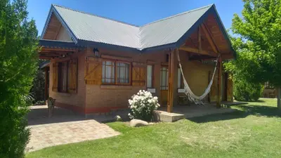 a house with a hammock in front of it at Complejo Tierra Mia in Panaholma