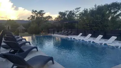 a swimming pool with lounge chairs and a swimming pool at Complejo Tierra Mia in Panaholma