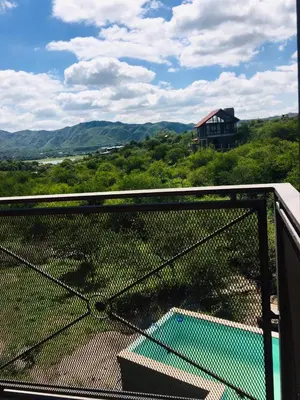 a balcony with a view of a house and a pool at Cañada Al Lago in Villa Parque Siquiman