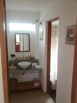 a bathroom with a sink and a mirror at Cañada Al Lago in Villa Parque Siquiman