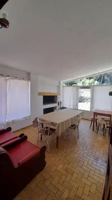 a large living room with a table and chairs at Apart Dany in Villa Los Molinos
