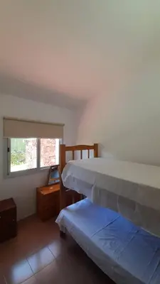 a bedroom with two beds and a window at Apart Dany in Villa Los Molinos
