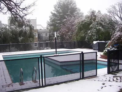 a swimming pool covered in snow with a fence at Complejo Entre Marte y La Luna in Merlo