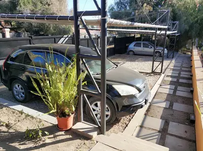 a car parked in a parking lot with a garage at Complejo Entre Marte y La Luna in Merlo