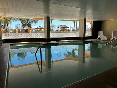 a swimming pool with a view of a resort at Hotel Mónaco in Villa Carlos Paz