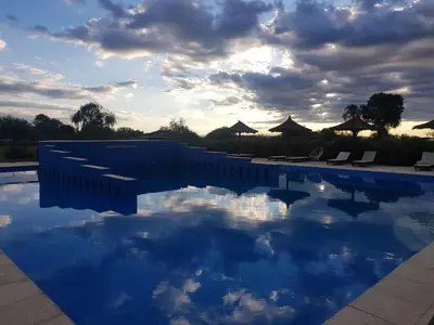a swimming pool with the sky in the water at La Maína Cabañas in San Javier