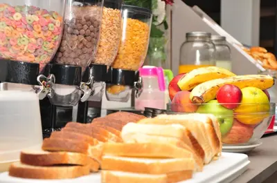 a table topped with lots of different types of food at Hotel Linz in Villa Carlos Paz