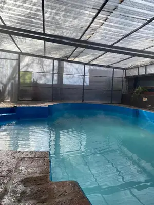an empty swimming pool with blue water at Carlos Paz Departamentos in Villa Carlos Paz