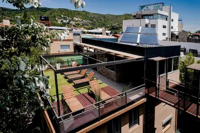 an aerial view of a building with a roof at Carlos Paz Departamentos in Villa Carlos Paz