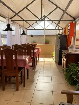 a dining room with tables and chairs in a tent at Carlos Paz Departamentos in Villa Carlos Paz