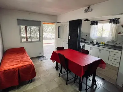 a kitchen with a table with a red table cloth on it at La Faustina Casas de Campo in Villa General Belgrano