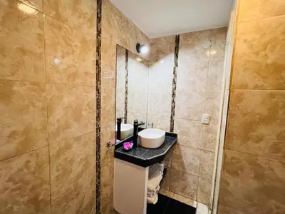 a bathroom with a sink and a shower at La Faustina Casas de Campo in Villa General Belgrano