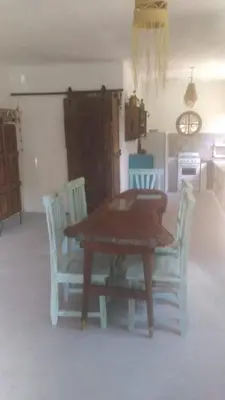 a wooden table and chairs in a room at Villa Verde Posada in Bialet Massé