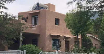 a large brown building with a window on top of it at Villa Verde Posada in Bialet Massé