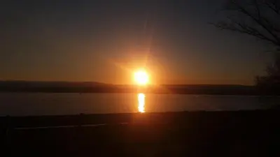a sun setting over a body of water at Villa Verde Posada in Bialet Massé