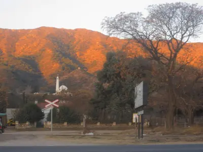 a mountain with autumn trees and a railroad crossing at Villa Verde Posada in Bialet Massé