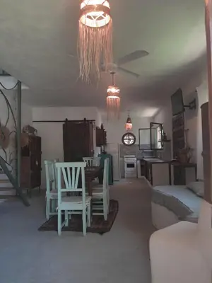 a living room with a table and chairs in a room at Villa Verde Posada in Bialet Massé