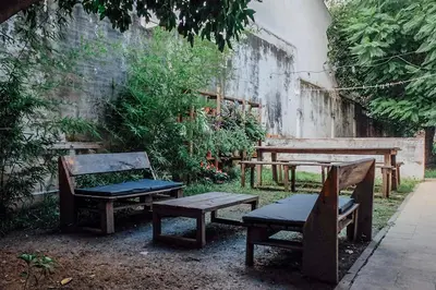 a group of benches and a table and benches at Casa Helsinki in Cordoba