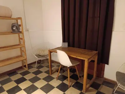 a wooden table and a chair in a room at Casa Helsinki in Cordoba