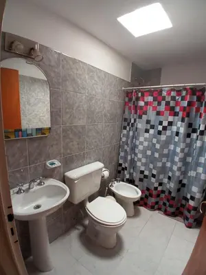 a bathroom with a sink and a toilet and a shower at Nuestro Rinconcito in Villa Cura Brochero